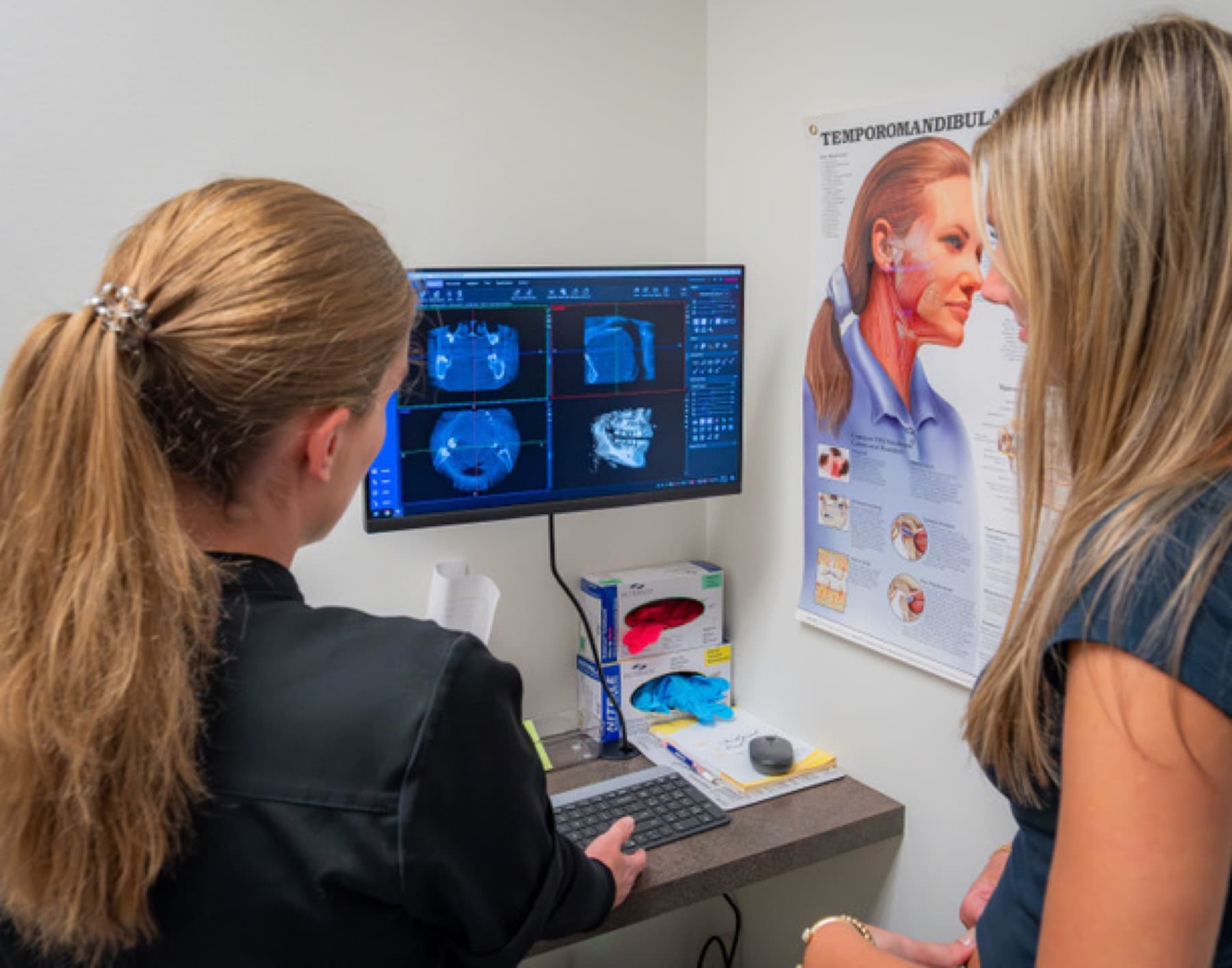 Dr. Kate Sudikoff reviewing care with a patient at iDental Dilworth in Charlotte, NC